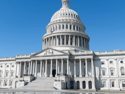 The U.S. Capitol building under a clear blue sky with no people present