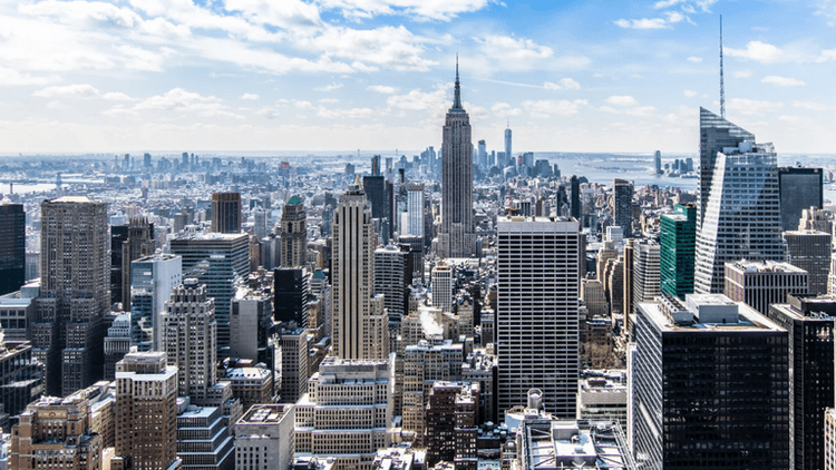 Panoramic view of New York City's skyline featuring the Empire State Building and skyscrapers