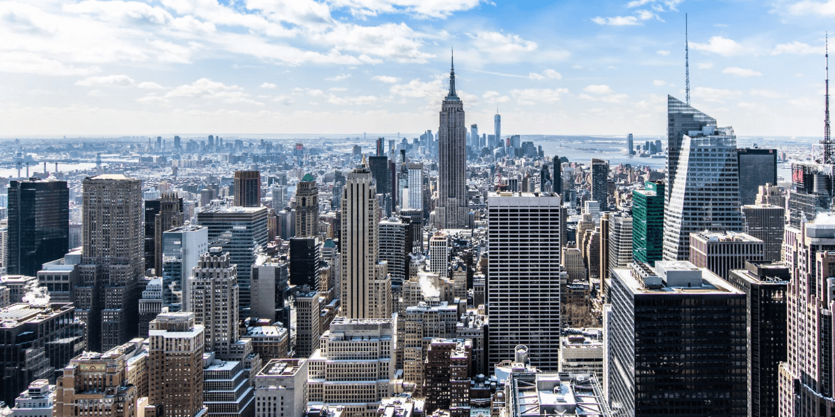 Panoramic view of New York City's skyline featuring the Empire State Building and skyscrapers
