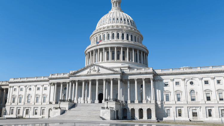 The U.S. Capitol building under a clear blue sky with no people present